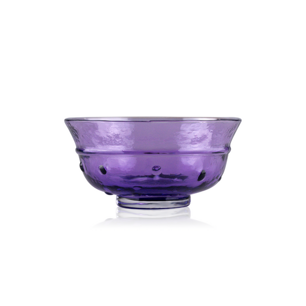 A vibrant purple handblown glass bowl with a textured design and a reflective finish, elegantly positioned against a pure white background, showcasing its translucent beauty and exquisite craftsmanship.