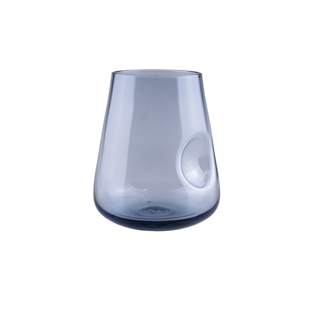 A smoky gray stemless wine glass with a unique thumb indent for ergonomic holding, featuring a graceful, modern design with a darker base that fades into a lighter tone towards the rim, presented against a neutral backdrop to showcase its sleek silhouette.