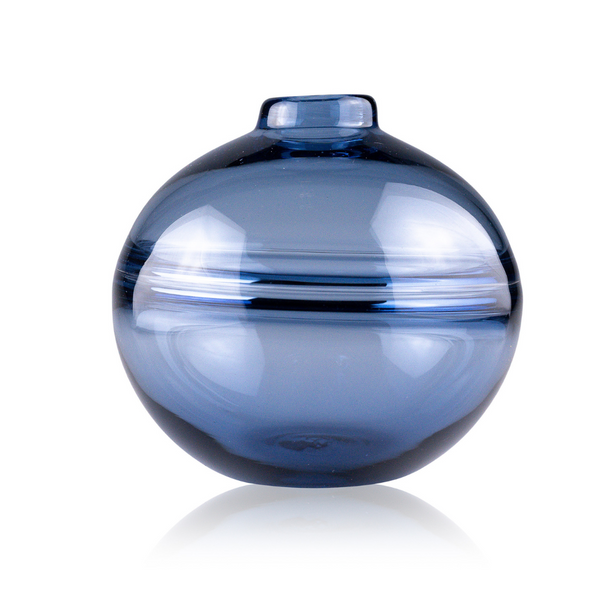 This is a rich, deep blue glass vase with a spherical silhouette and a centered, narrow opening, accented by a clear glass band circling its equator. The bold color and circular form make a striking visual statement, all set against a crisp white background that makes the vase's color pop.