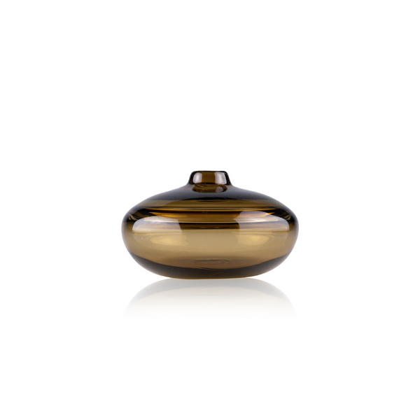 A sleek, amber-colored glass vase with a spherical body and a small, flat lid, featuring a glossy finish and a prominent horizontal stripe reflecting light. The vase's design combines modern aesthetic with classic elegance, set against a pure white background for a striking visual contrast.