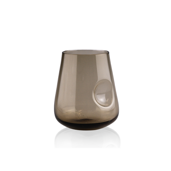 An elegant, smoky taupe stemless wine glass with a thumb indent for comfortable holding, blending seamlessly from a deeper shade at the base to a lighter tone towards the top, presented against a clean white background for a subtle, sophisticated look.
