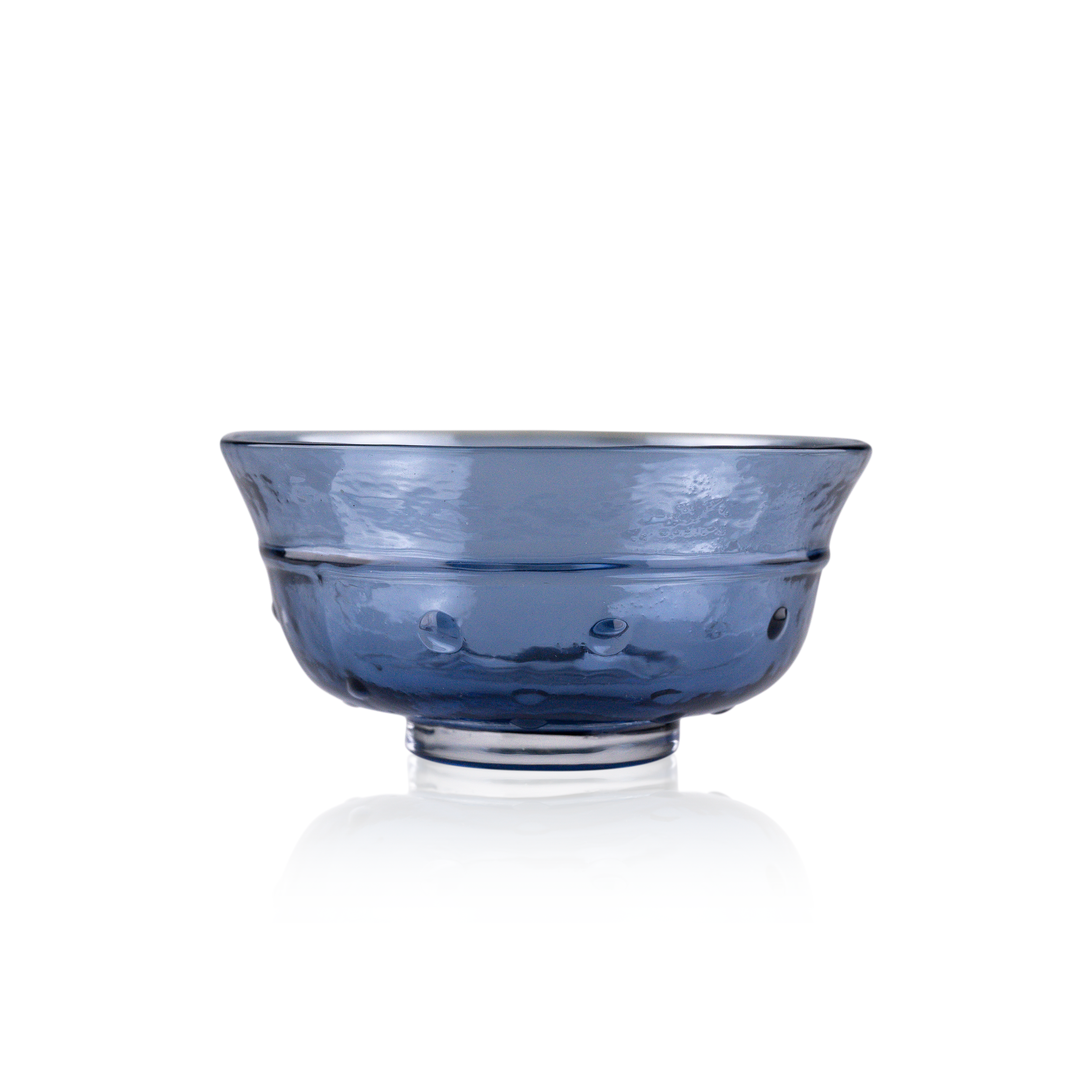 A classic deep glass bowl with a textured exterior and smooth rim, sitting on a clear base. The bowl's rich color and subtle design elements are highlighted against a pure white background, exemplifying timeless glass craftsmanship.