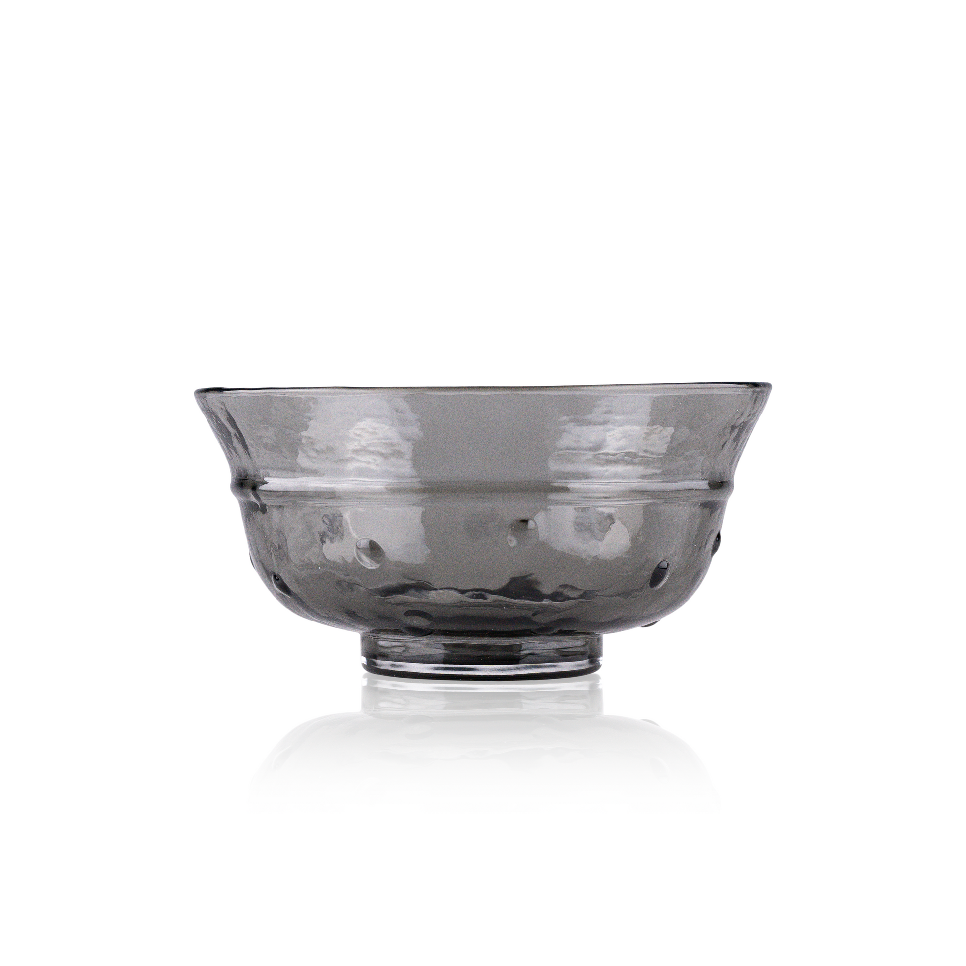 A classic deep glass bowl with a textured exterior and smooth rim, sitting on a clear base. The bowl's rich color and subtle design elements are highlighted against a pure white background, exemplifying timeless glass craftsmanship.