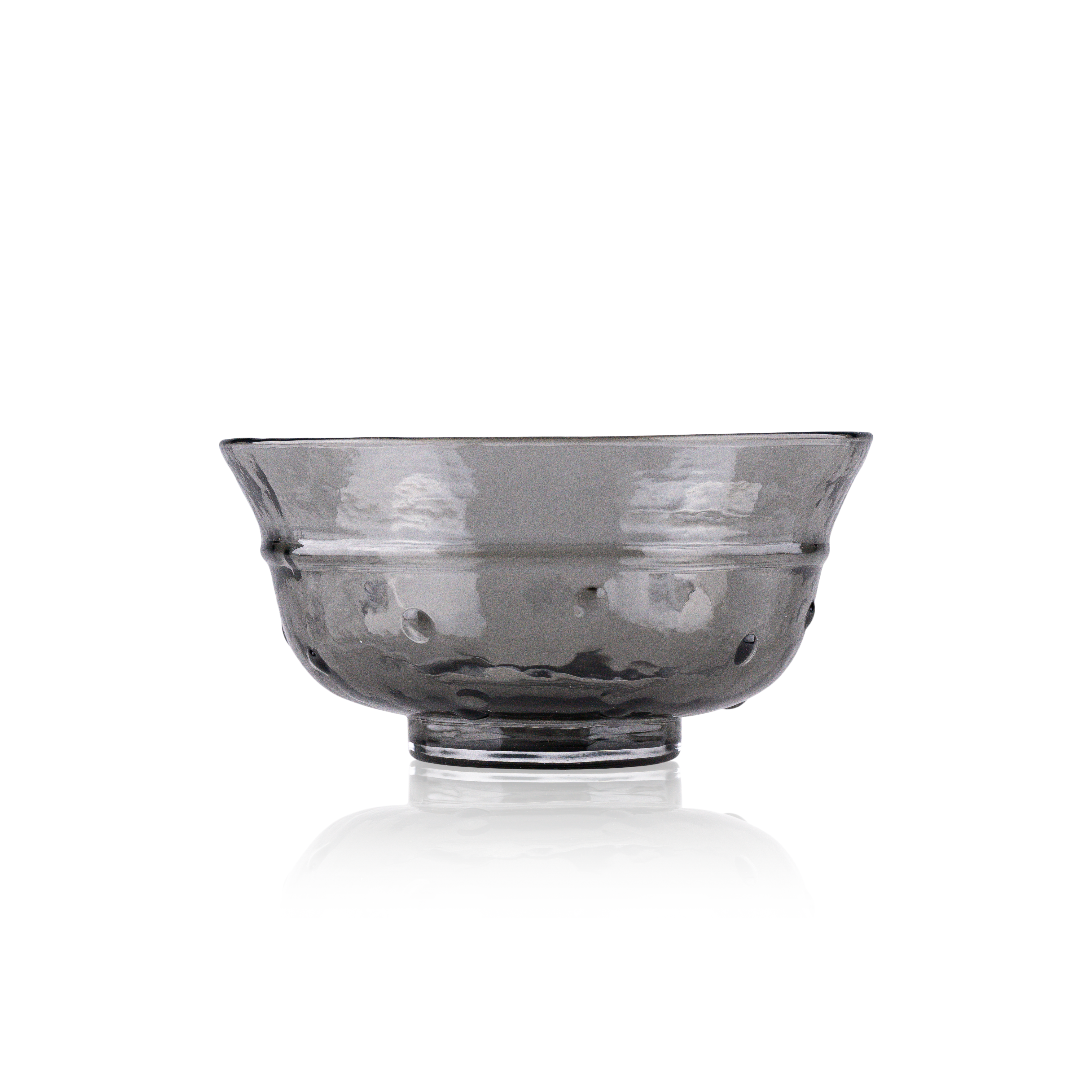 A classic deep glass bowl with a textured exterior and smooth rim, sitting on a clear base. The bowl's rich color and subtle design elements are highlighted against a pure white background, exemplifying timeless glass craftsmanship.