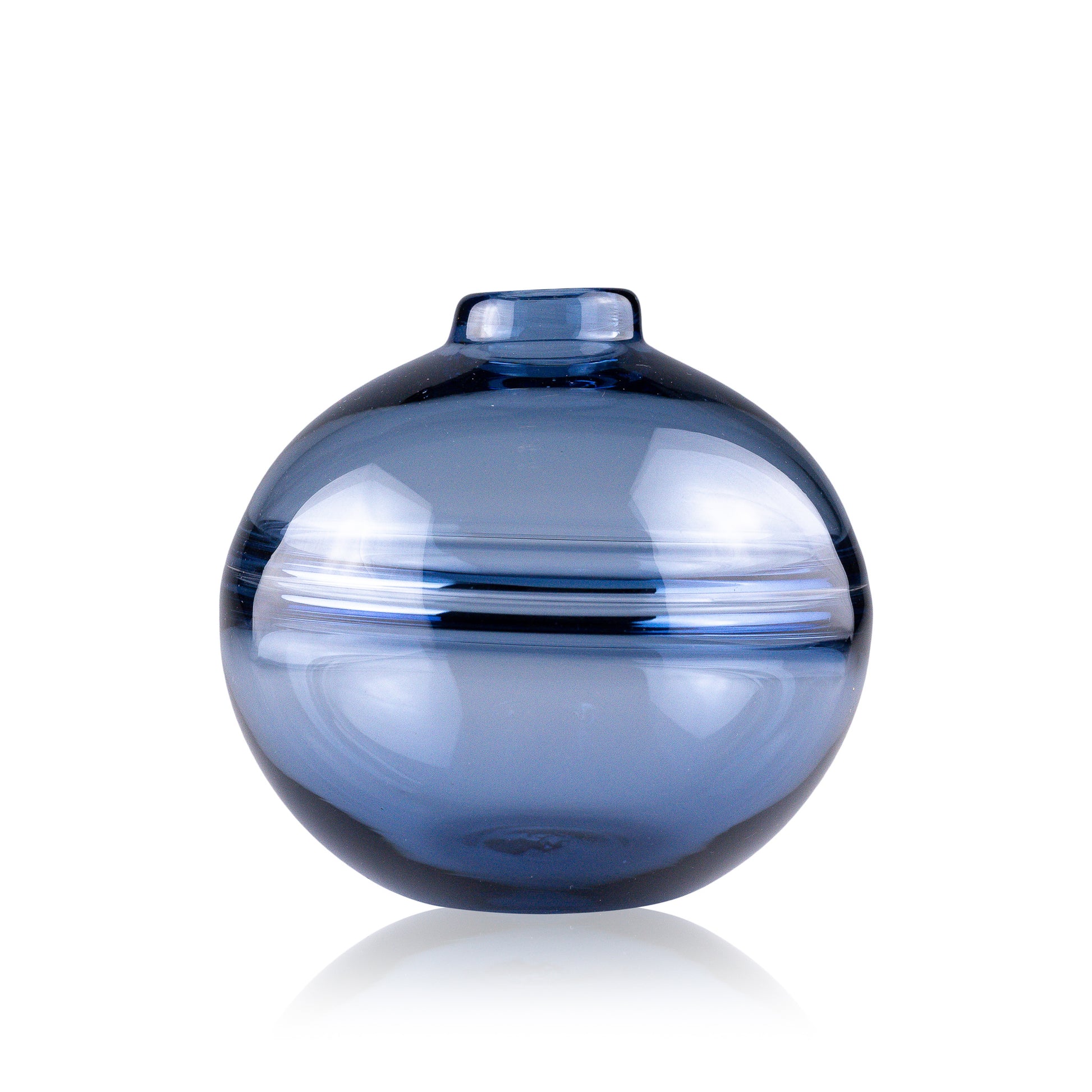 Round-bottomed halo glass vases in varying sizes, each with a small opening at the top, creating a harmonious arrangement of translucent, warm-toned spheres on a reflective surface