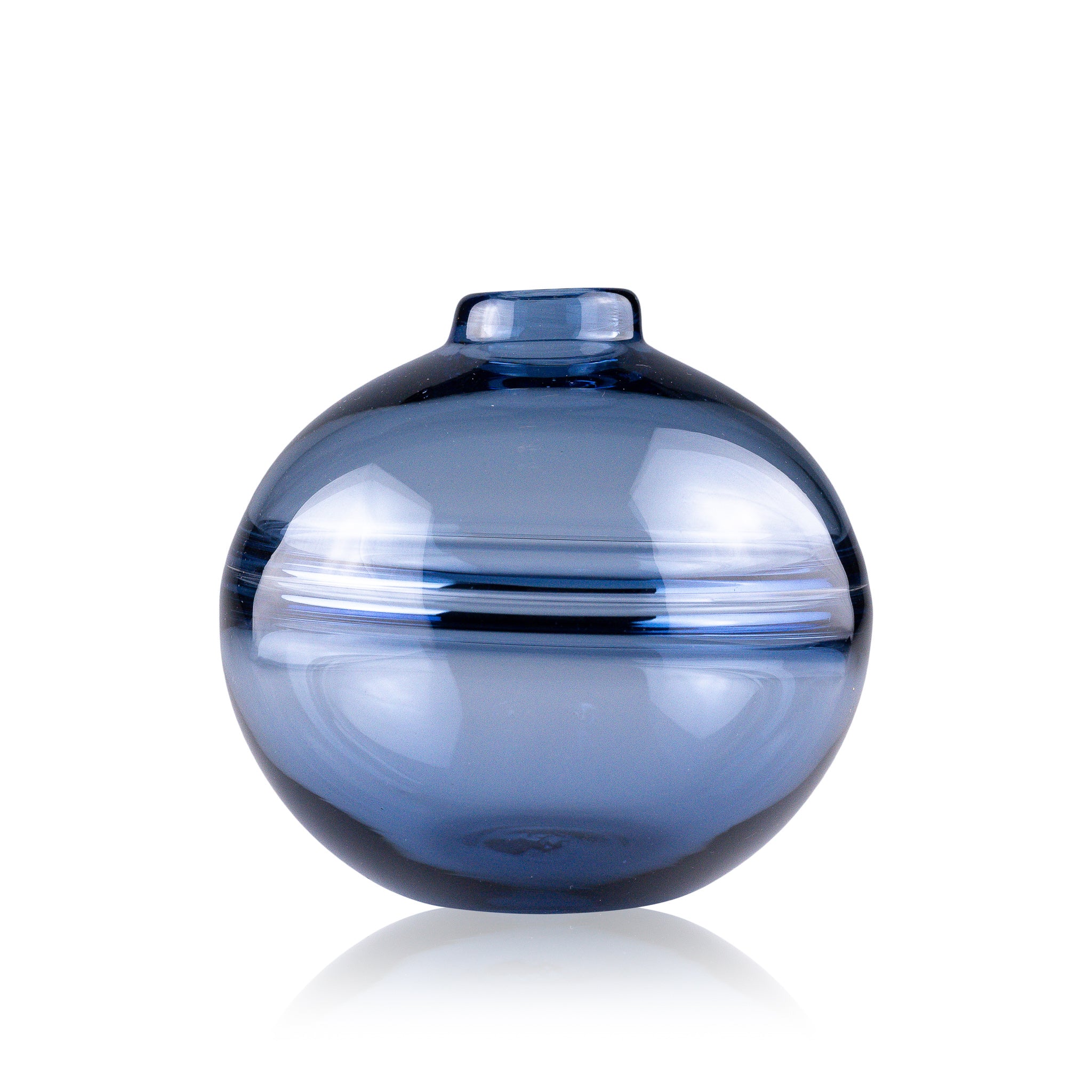 Round-bottomed halo glass vases in varying sizes, each with a small opening at the top, creating a harmonious arrangement of translucent, warm-toned spheres on a reflective surface