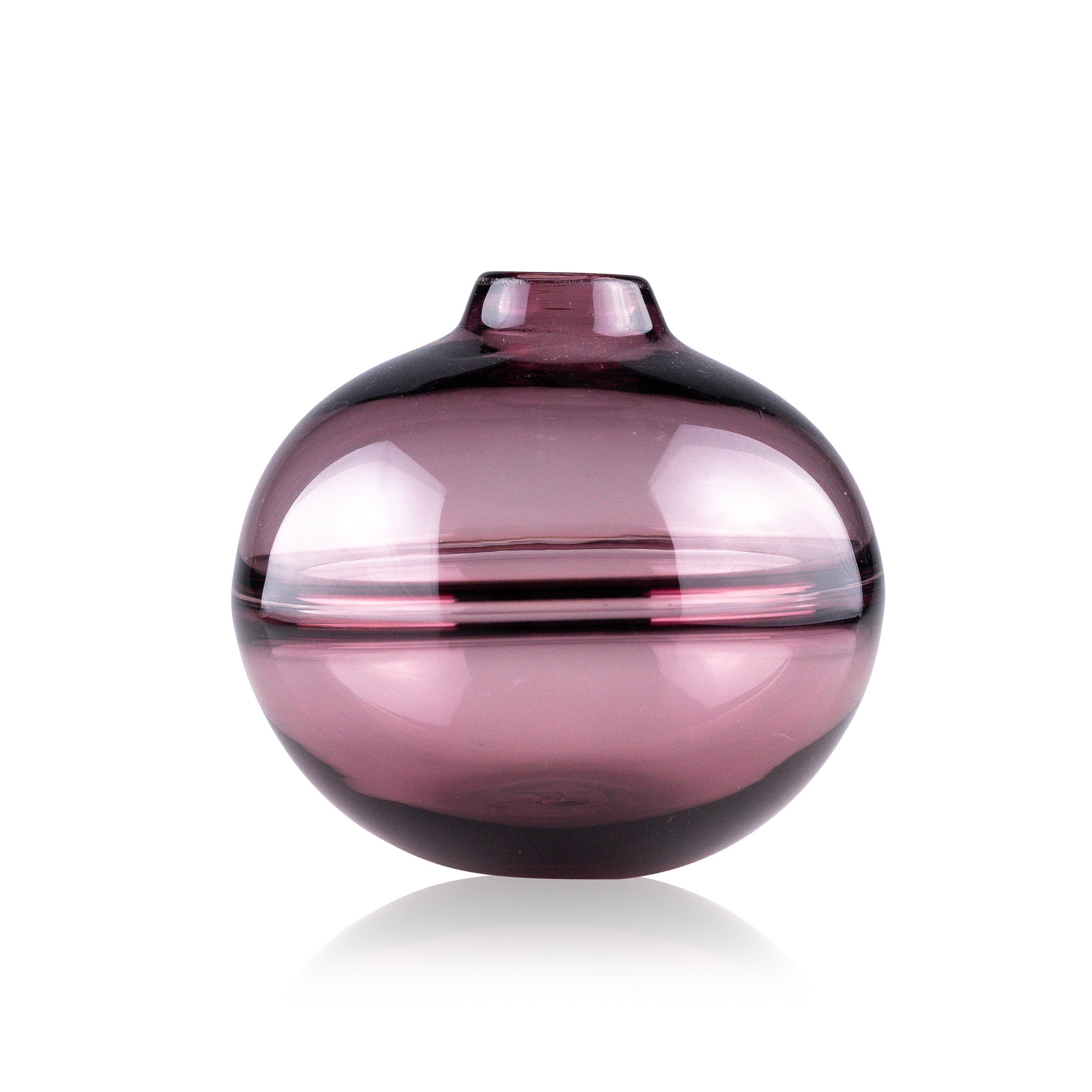 Round-bottomed halo glass vases in varying sizes, each with a small opening at the top, creating a harmonious arrangement of translucent, warm-toned spheres on a reflective surface