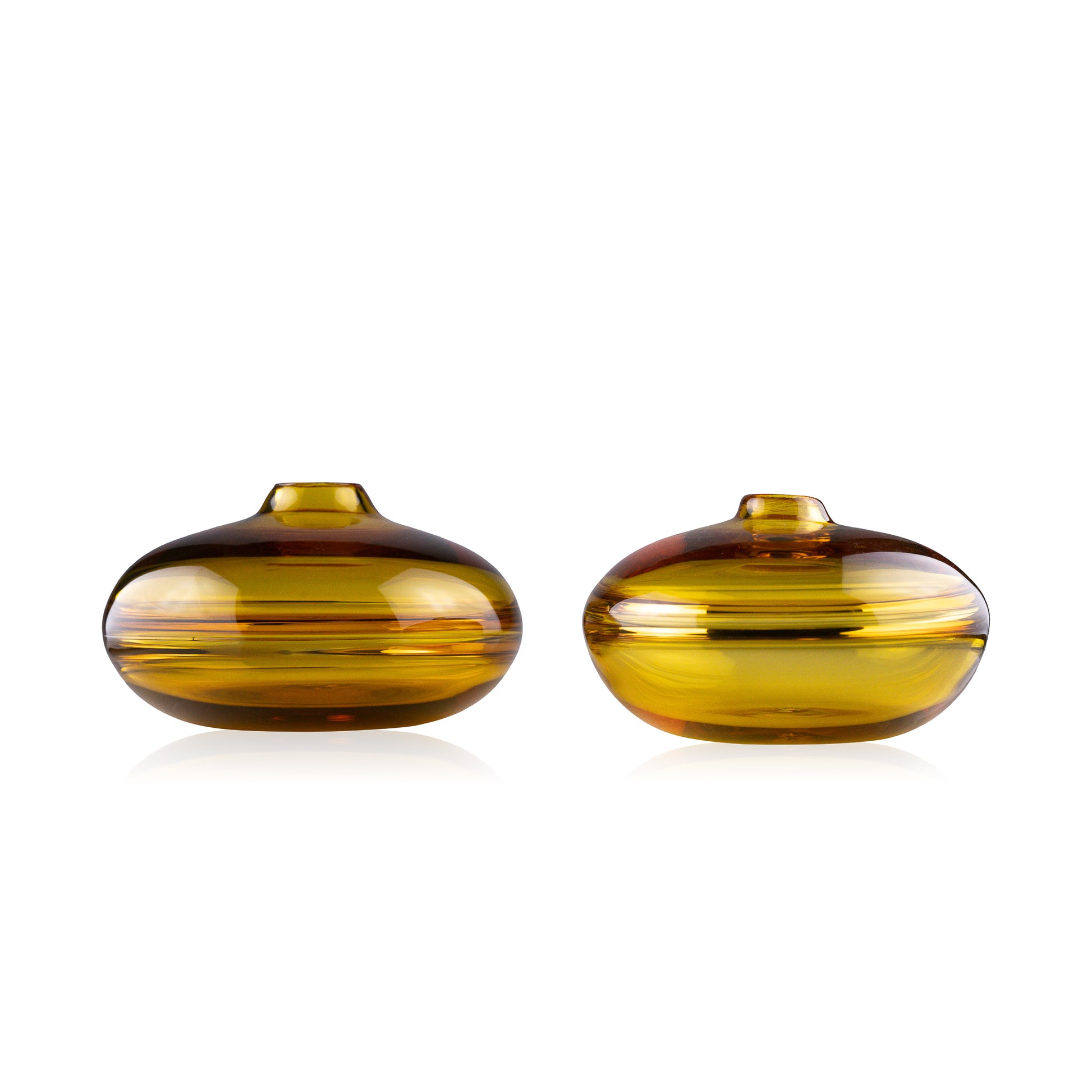 A squat glass vessel with a wide, flattened body and a narrow, raised lid, photographed against a white background, showcasing its smooth lines and tranquil, translucent color, reflective of serene, contemporary glass artistry.