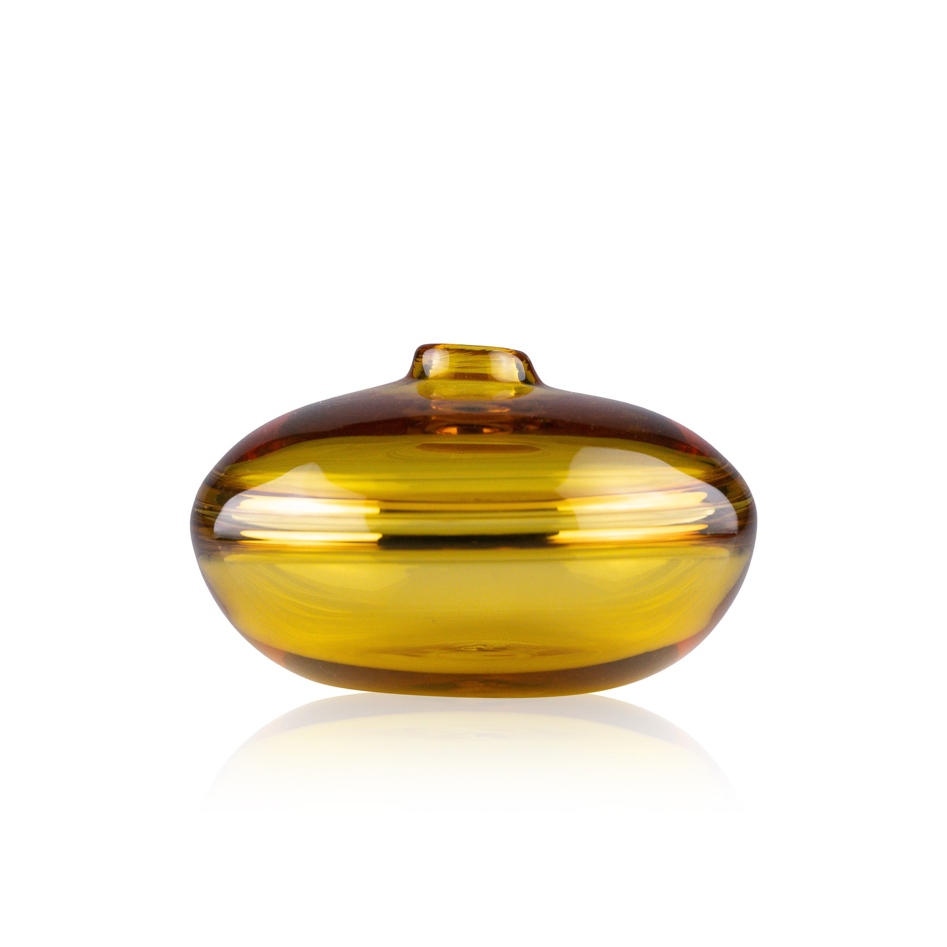 A squat glass vessel with a wide, flattened body and a narrow, raised lid, photographed against a white background, showcasing its smooth lines and tranquil, translucent color, reflective of serene, contemporary glass artistry.