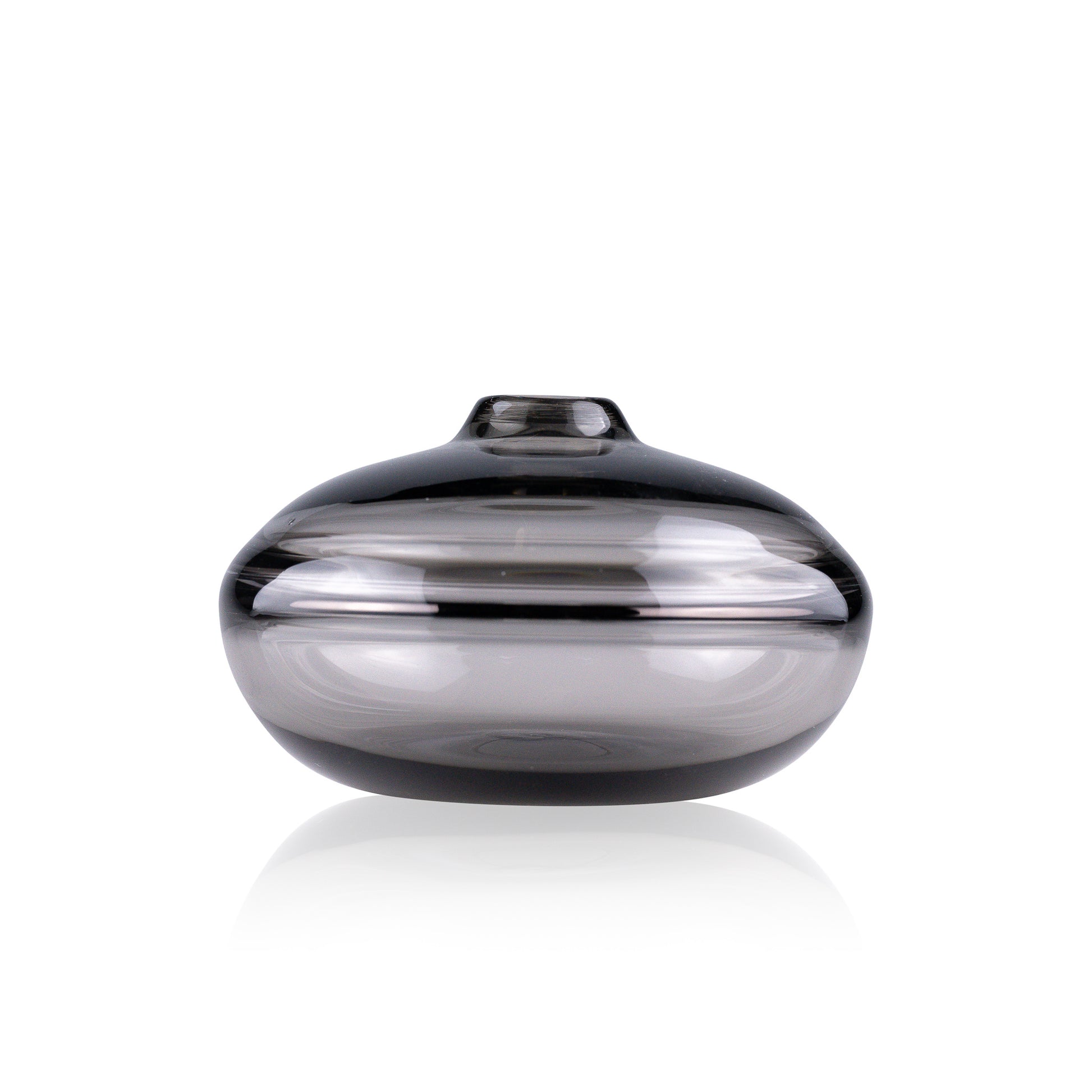 A squat glass vessel with a wide, flattened body and a narrow, raised lid, photographed against a white background, showcasing its smooth lines and tranquil, translucent color, reflective of serene, contemporary glass artistry.