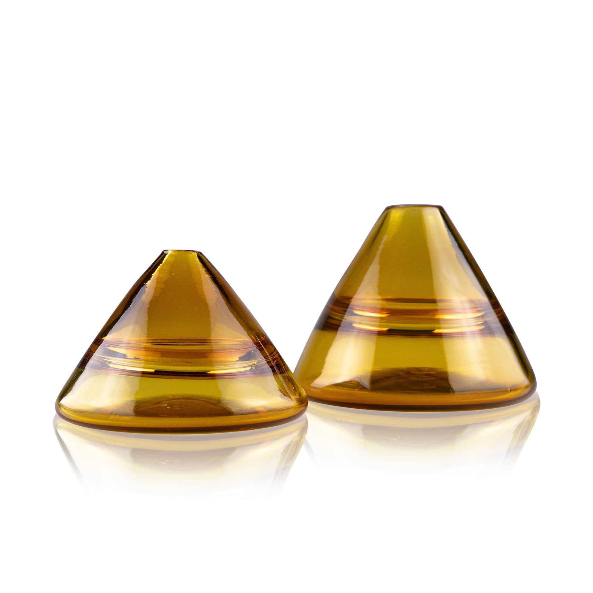 Unconventional halo vase with a conical shape, arranged in a staggered formation and reflected on a glossy surface, highlighting their sleek and contemporary design.