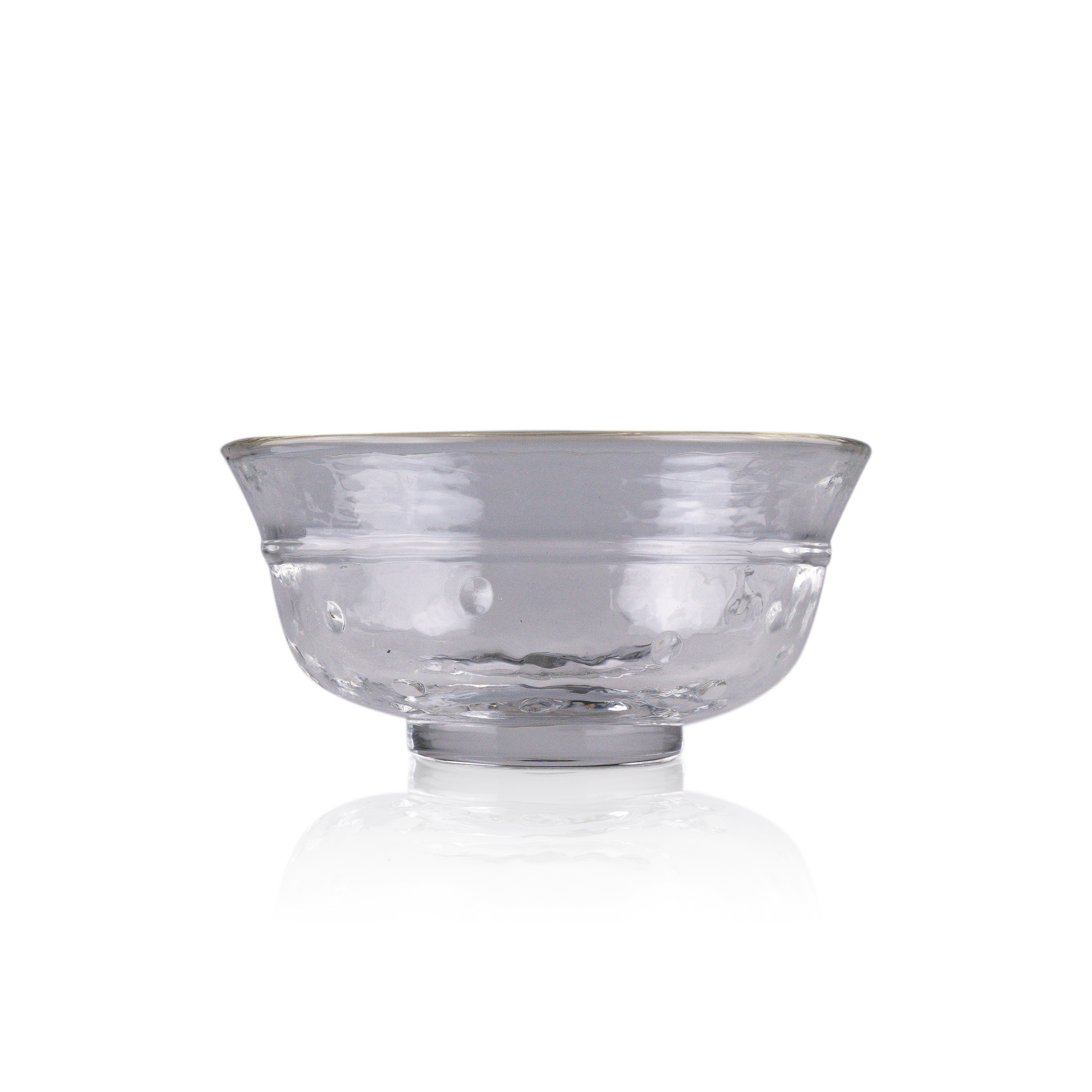A classic deep glass bowl with a textured exterior and smooth rim, sitting on a clear base. The bowl's rich color and subtle design elements are highlighted against a pure white background, exemplifying timeless glass craftsmanship.