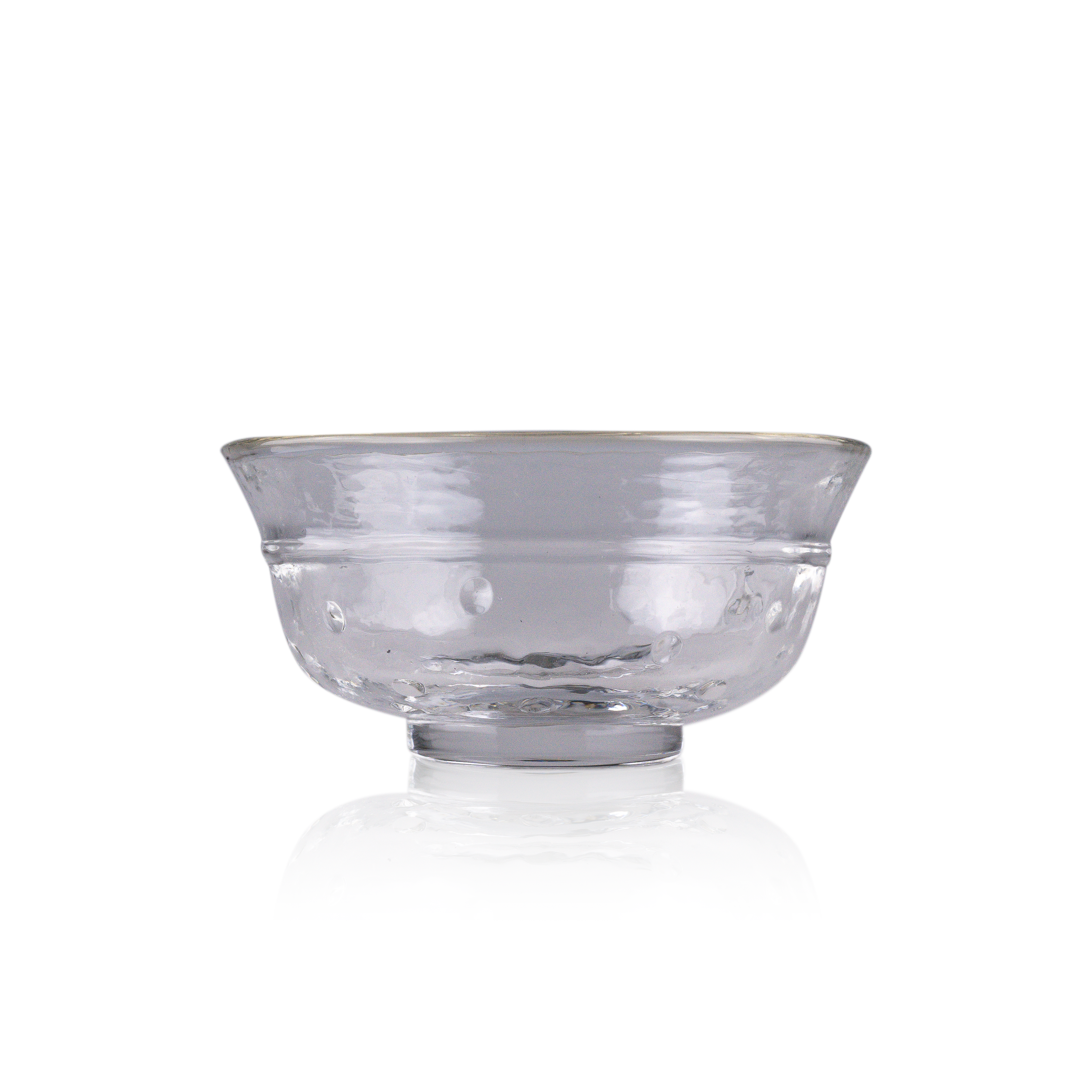 A classic deep glass bowl with a textured exterior and smooth rim, sitting on a clear base. The bowl's rich color and subtle design elements are highlighted against a pure white background, exemplifying timeless glass craftsmanship.