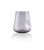 A stemless wine glass with a rounded base and distinctive thumb indent, showcased against a reflective surface with a black backdrop to enhance the glass's warm hues.
